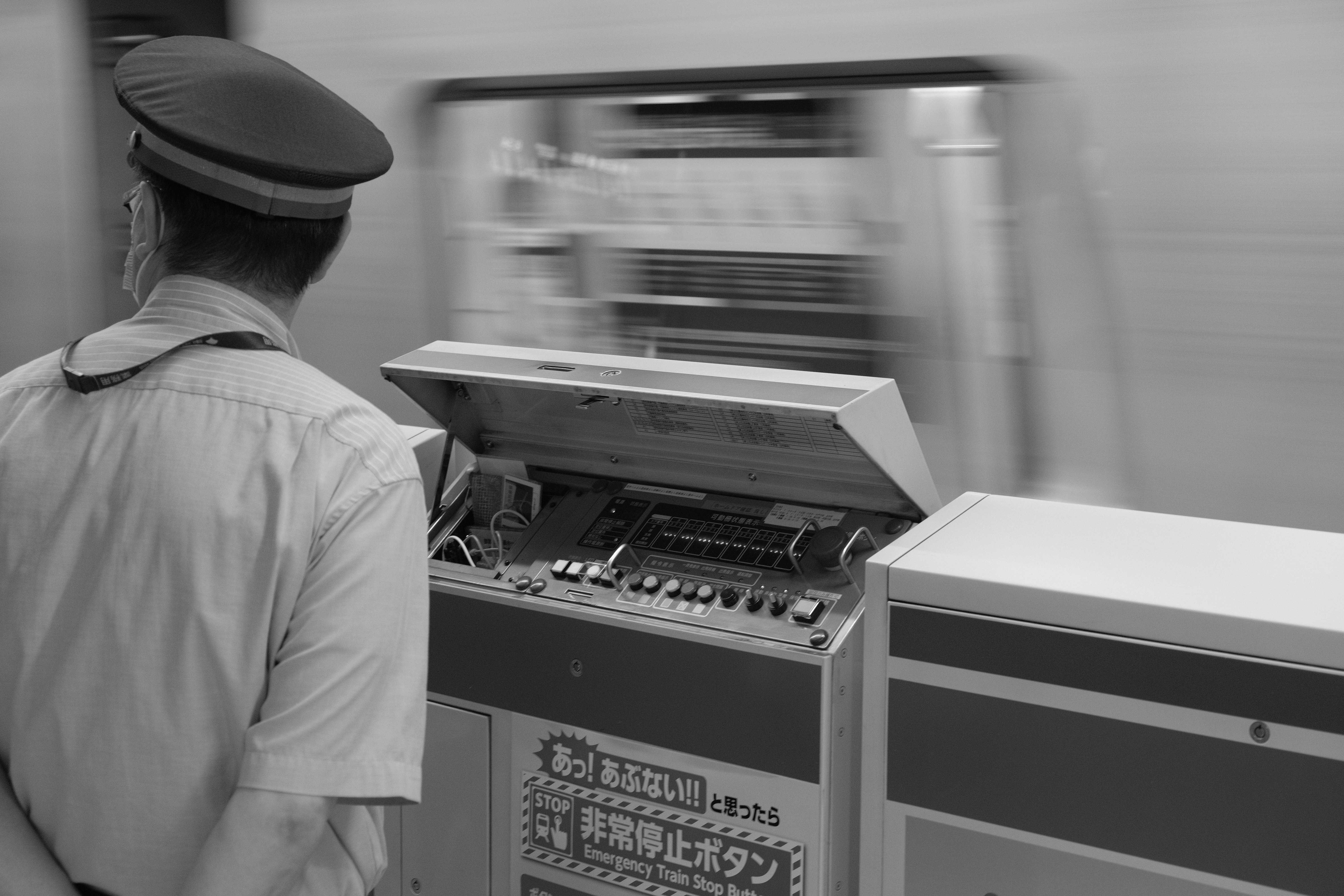A man standing next to a machine in a train station